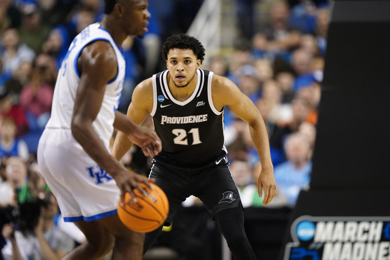 GREENSBORO, NORTH CAROLINA - MARCH 17: Clifton Moore #21 of the Providence Friars defends against Oscar Tshiebwe #34 of the Kentucky Wildcats during the first half in the first round of the NCAA Men's Basketball Tournament at The Fieldhouse at Greensboro Coliseum on March 17, 2023 in Greensboro, North Carolina. (Photo by Jacob Kupferman/Getty Images)