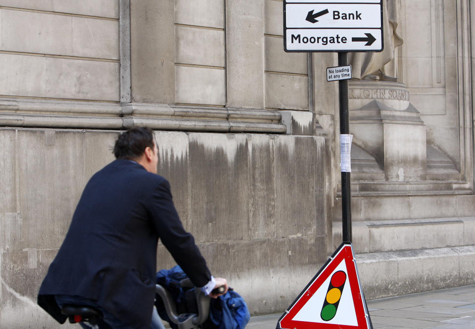 A cyclist passes a sign post indicating the direction to 'bank' near the Bank of England in London, Friday, Aug. 19, 2011. Global stocks slid again Friday as fears of a possible U.S. recession combined with ongoing worries over Europe's debt crisis, which is stoking acute fears over the continent's banking sector. (AP Photo/Akira Suemori)