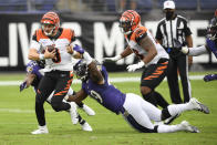 Cincinnati Bengals quarterback Joe Burrow (9) avoids a tackle by Baltimore Ravens outside linebacker Matt Judon (99) while scrambling for yardage during the first half of an NFL football game, Sunday, Oct. 11, 2020, in Baltimore. (AP Photo/Nick Wass)