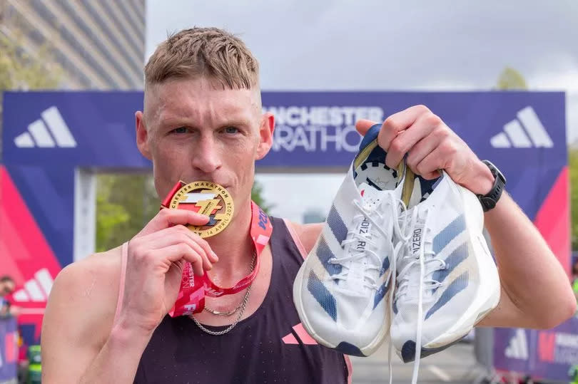 Adam Clarke, winner of the Manchester Marathon 2024 with a time of 2:16:29, with his medal.