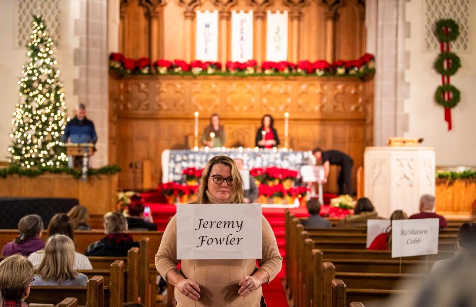 Jeremy Fowler's name is carried after being announced during the Homeless Memorial Vigil held by Beacon Inc. at First Christian Church on Wednesday, Dec. 13, 2023.