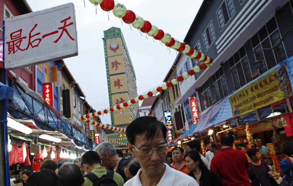 People shop for new year goodies ahead of the Lunar New Year at Chinatown in Singapore January 24, 2014. The Lunar New Year which falls on January 31 marks the year of the horse. Sign reads &quot;Final Day (of sale)&quot; REUTERS/Edgar Su (SINGAPORE - Tags: SOCIETY)