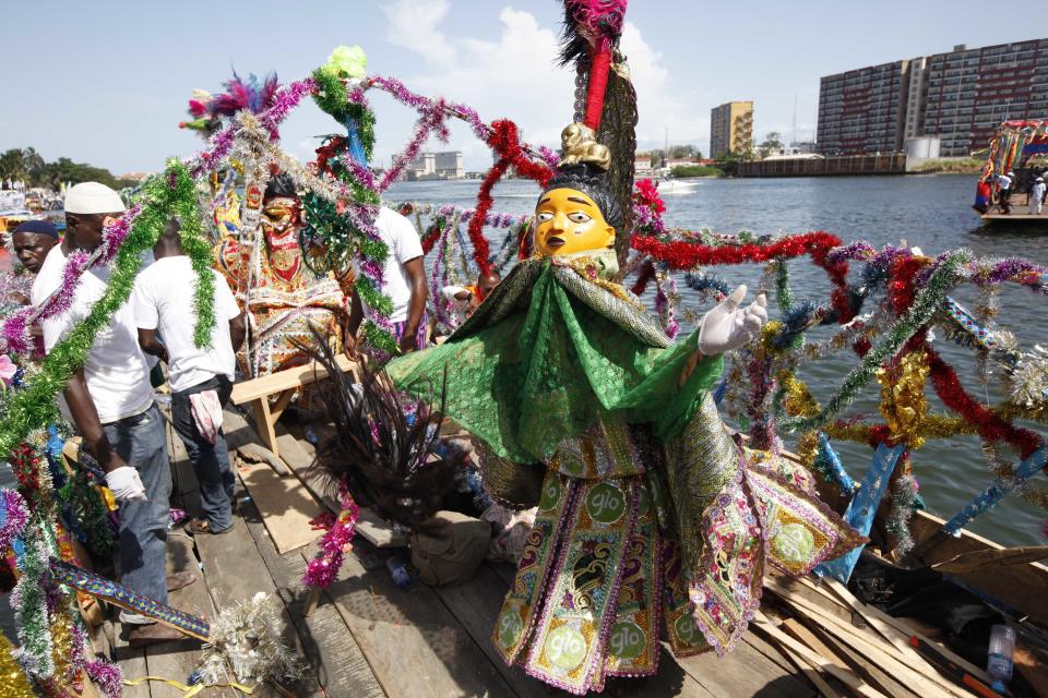 Men dressed in costumes take part in a parade during a regatta in Lagos, Nigeria on Sunday, March. 31, 2013. Organizers held a boat regatta Sunday as part of the ongoing Lagos Carnival. The carnival will come to its height Monday as dancers and masqueraders walk through the streets of Lagos' two main islands.( AP Photos/Sunday Alamba)