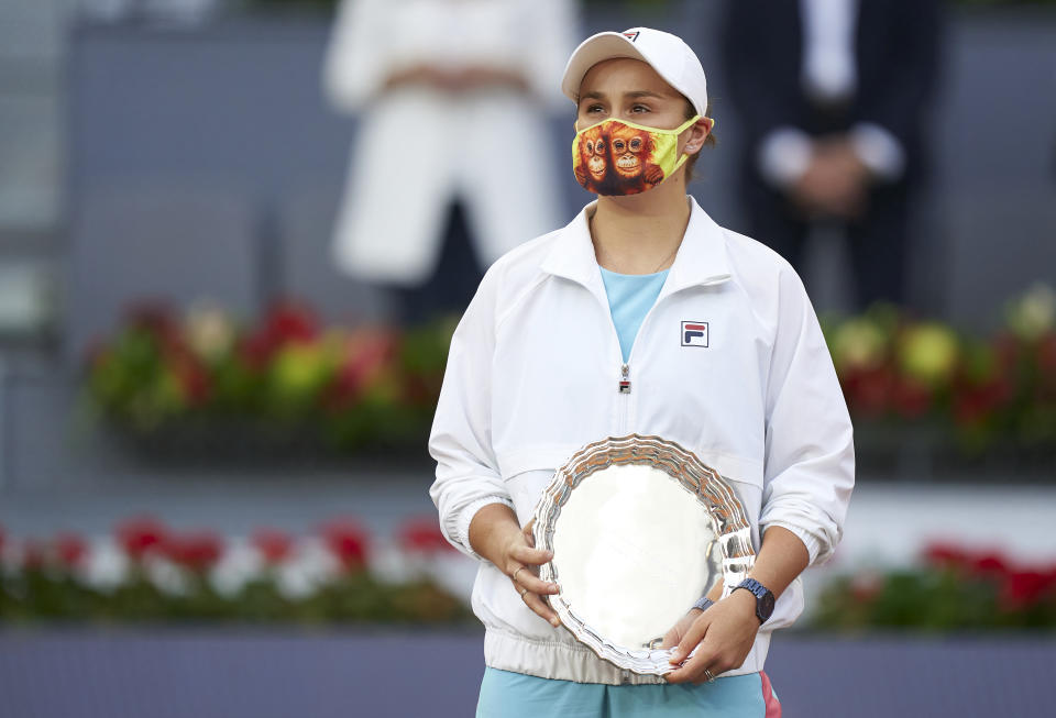 Ash Barty (pictured) holding her trophy at the Madrid Open.
