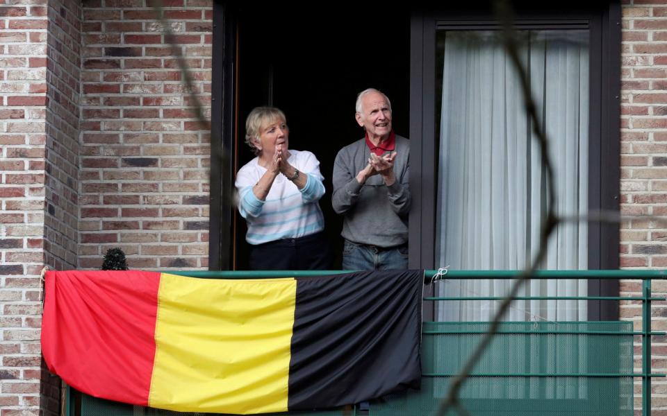 Belgians applaud to celebrate medical personnel dealing with the coronavirus disease - YVES HERMAN/REUTERS