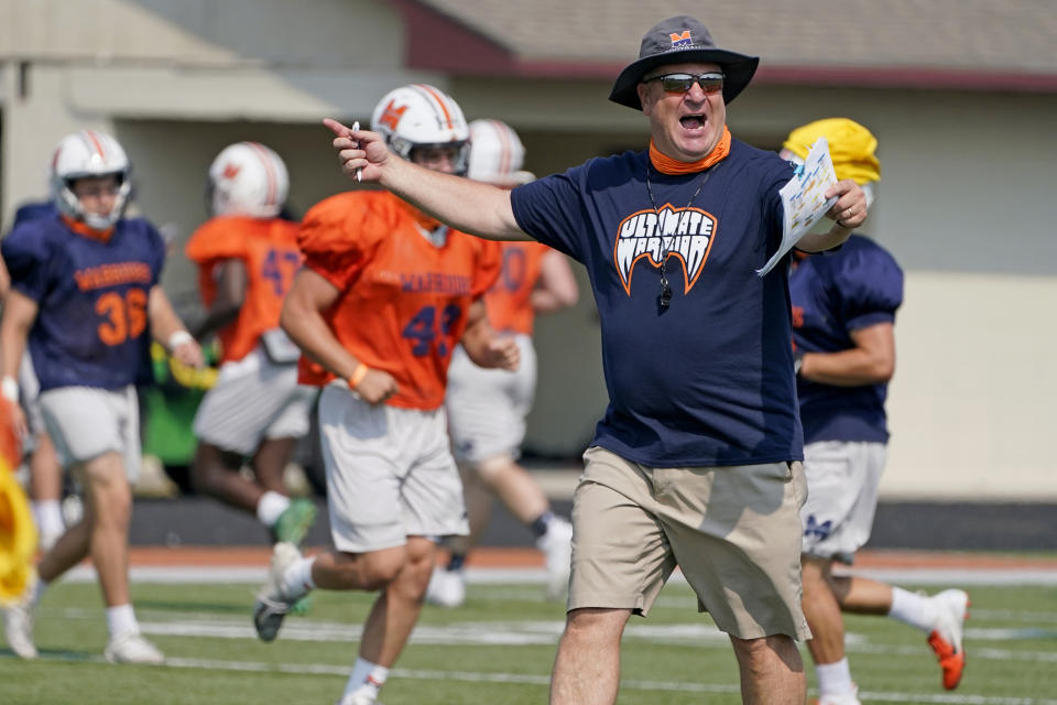 Midland University head coach Jeff Jamrog calls a play during NAIA college football practice in Fremont, Neb., Tuesday, Aug. 25, 2020. Midland University is among five small colleges in the state that are pushing forward with plans to play football this fall. The Nebraska Cornhuskers, meanwhile, won't play after Big Ten presidents voted to move back football season until after Jan. 1. (AP Photo/Nati Harnik)