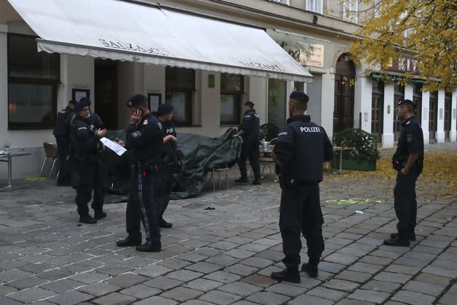 Police officers guard the crime scene at a restaurant in Vienna, Austria