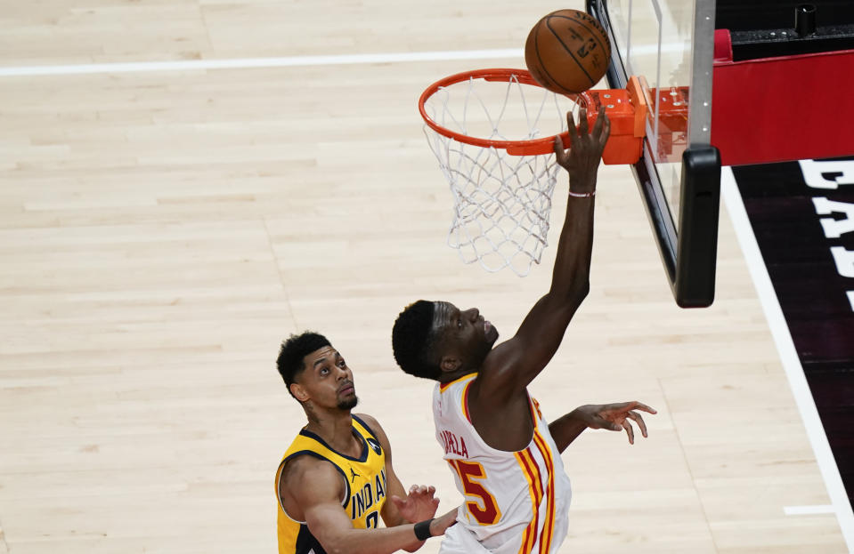 Atlanta Hawks center Clint Capela (15) shoots and scores during the second half of an NBA basketball game against the Indiana Pacers on Sunday, April 18, 2021, in Atlanta. (AP Photo/Brynn Anderson)