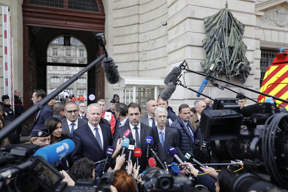 French Interior Minister Christophe Castaner, center, and Paris police prefect Didier Lallement, right next to Castaner, give a press conference outside the Paris police headquarters, Thursday, Oct.3, 2019 in Paris. An employee armed with a knife attacked officers inside Paris police headquarters Thursday, killing at least four before he was fatally shot, a French police union official said. (AP Photo/Kamil Zihnioglu)