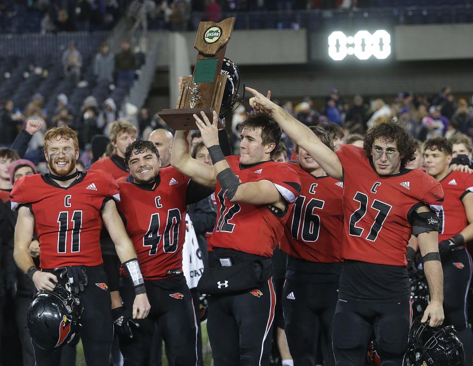 Canfield celebrates with the Division III state championship trophy after beating Bloom-Carroll at Tom Benson Hall of Fame Stadium in Canton, Friday, Dec. 2, 2022.