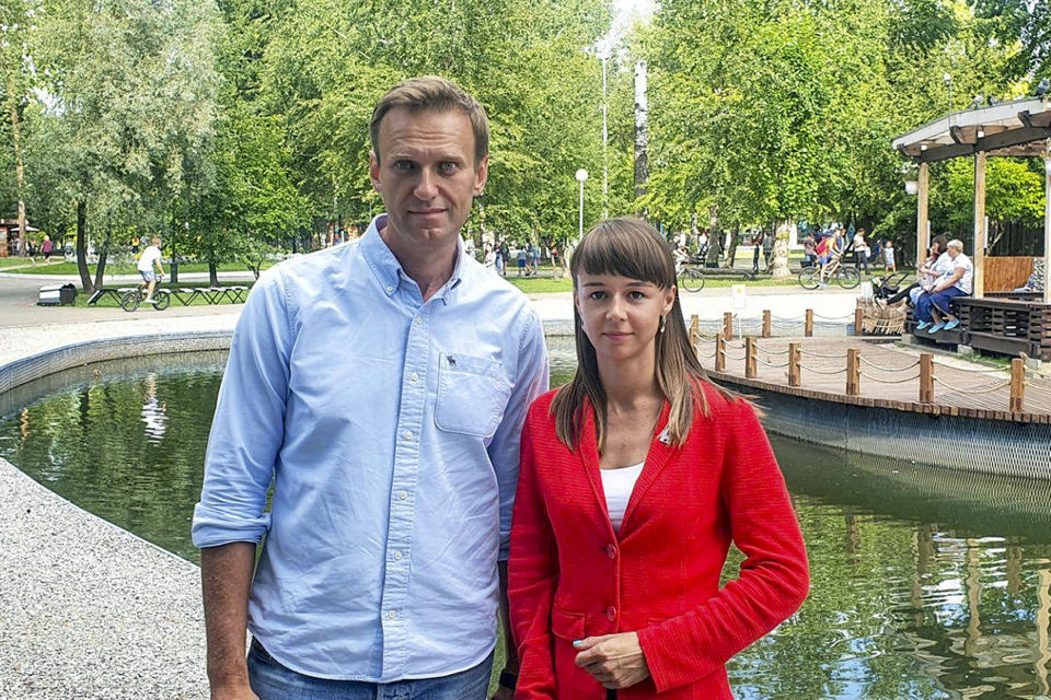 In this August 2020, photo, provided by Alexei Navalny's team, Ksenia Fadeyeva, right, poses for a photo with Alexei Navalny in Tomsk, Russia. Fadeyeva runs the regional headquarters in the Siberian city and is running for the Tomsk city council. Fadeyeva has secured a seat in the city council, according to preliminary results of the regional election that took place on Sunday, Sept. 13, 2020. (Andrei Fateyev/Alexei Navalny's team via AP)