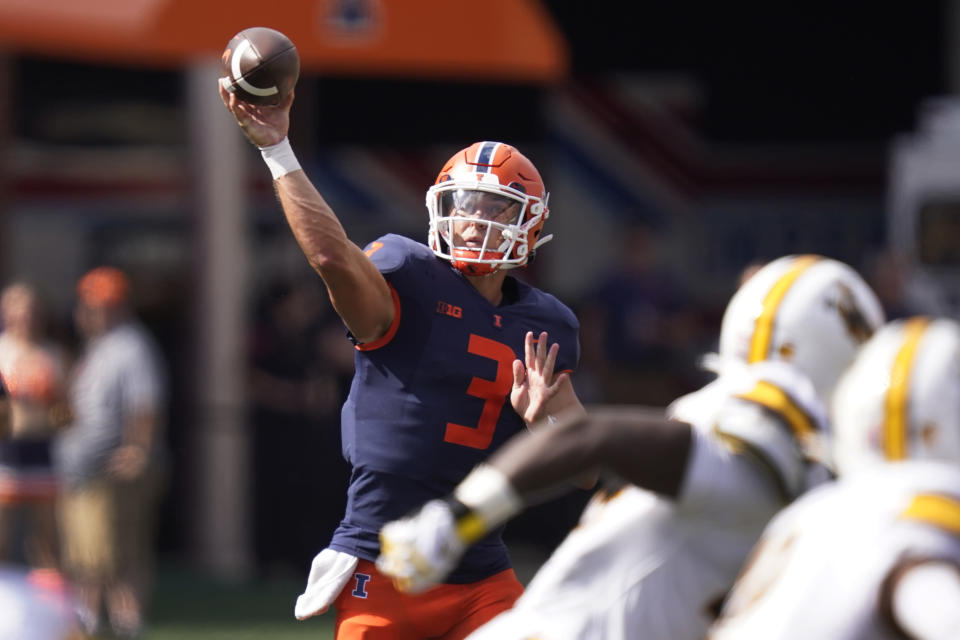 Illinois quarterback Tommy DeVito passes during the first half of an NCAA college football game against Wyoming, Saturday, Aug. 27, 2022, in Champaign, Ill. (AP Photo/Charles Rex Arbogast)