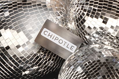 A silver chipotle gift card on top of a pile of disco balls