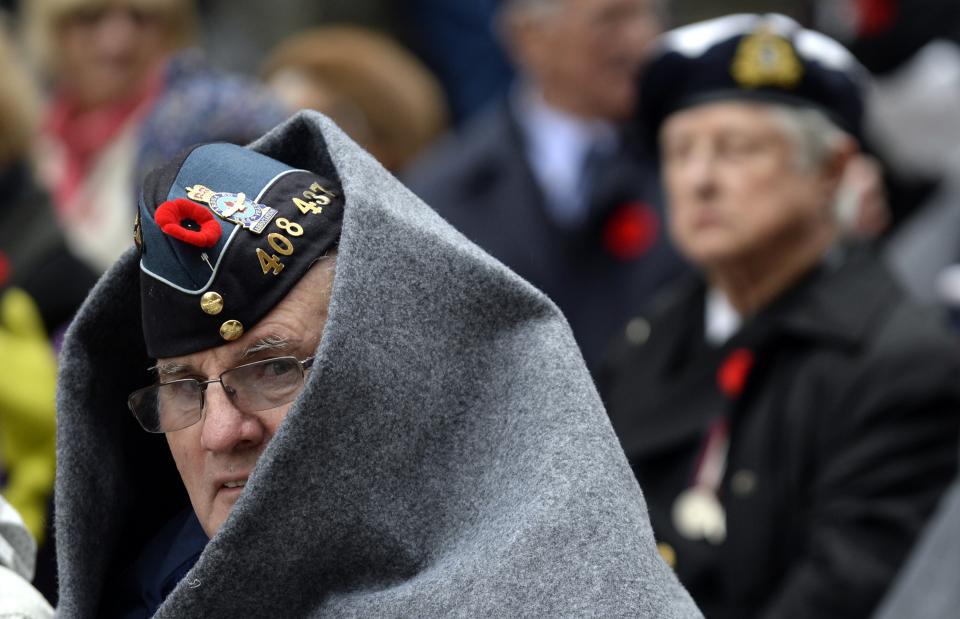 Andy Jack, 75, looks out from a blanket during Remembrance Day ceremonies at Old City Hall in Toronto