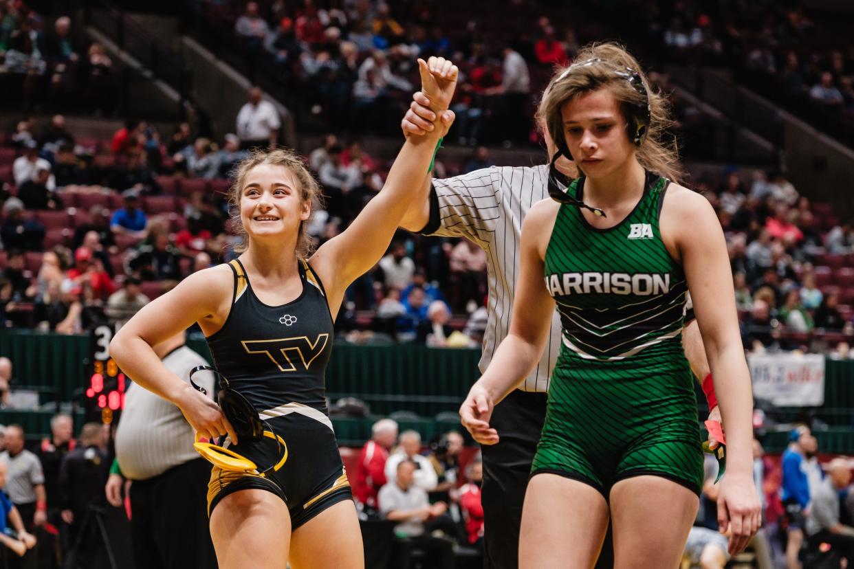 Tri-Valley's Kandice Spry celebrates her defeat of Harrison's Leah Willen during day three of the Ohio High School Athletic Association 2024 State Wrestling Championships, Sunday, March 10 at The Ohio State University Jerome Schottenstein Center, in Columbus.