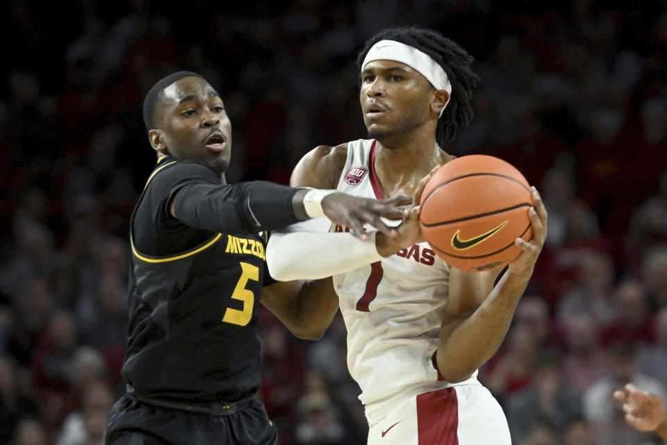 Missouri guard D'Moi Hodge (5) defends against Arkansas guard Ricky Council IV (1) during the first half of an NCAA college basketball game Wednesday, Jan. 4, 2023, in Fayetteville, Ark. (AP Photo/Michael Woods)