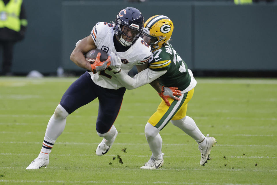 Chicago Bears wide receiver DJ Moore (2) struggles for yardage as Green Bay Packers cornerback Carrington Valentine (37) defends during the first half of an NFL football game Sunday, Jan. 7, 2024, in Green Bay, Wis. (AP Photo/Mike Roemer)
