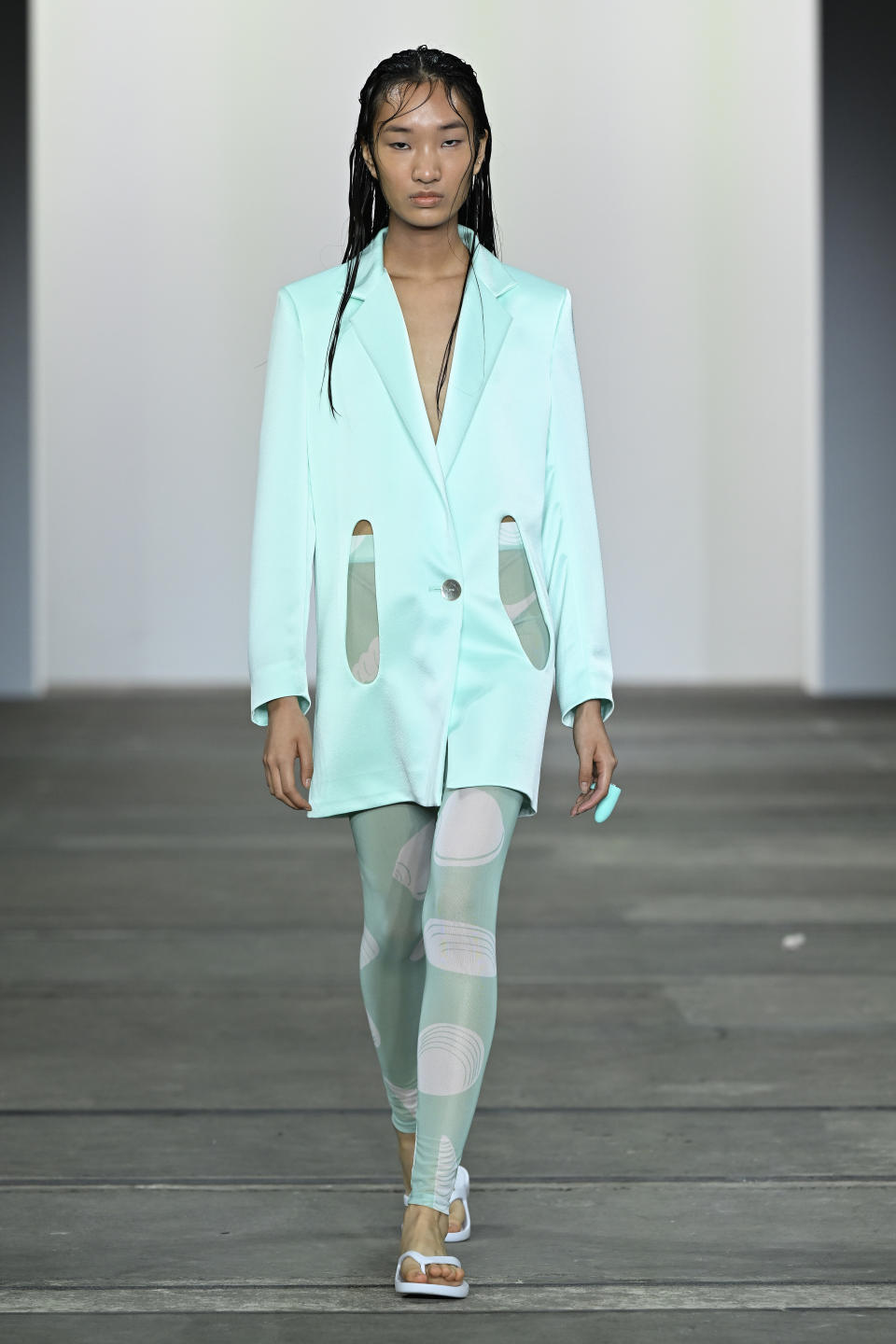 A model at the Karla Spetic runway show at Fashion Week wears a sea-green blazer over patterned tights and on her finger is a Lovehoney Tease Finger Vibrator sex toy to match her outfit. Credit: Karla Spetic