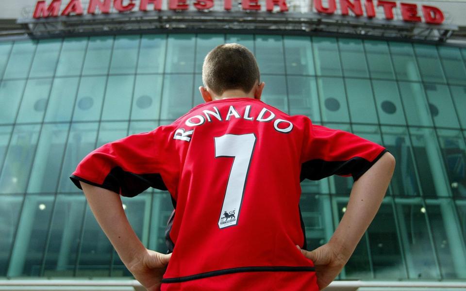 Manchester United fan Steven Markey wears a replica kit bearing the name of the club's new signing Cristiano Ronaldo outside Old Trafford, Manchester, Wednesday August 13, 2003 - PA