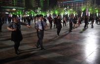 Han Chinese couples dance in a square in Hotan, in China's western Xinjiang region, April 15, 2015