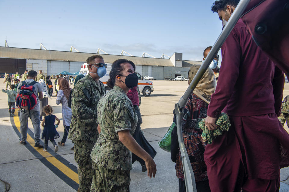 In this image provided by the U.S. Navy and taken on the military base in Rota, near Cadiz in southern Spain on Friday Aug. 27, 2021, evacuees from Afghanistan arrive at the Rota navy base. (U.S. Navy photo by Mass Communication Specialist 2nd Class John Owen, via AP)