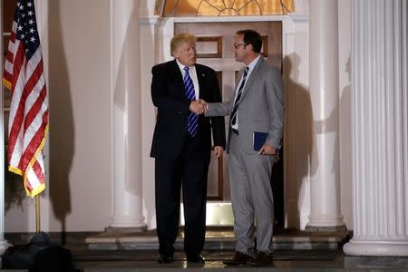 U.S. President-elect Donald Trump stands with Todd Ricketts, co-owner of the MLB baseball team the Chicago Cubs, following their meeting at the main clubhouse at Trump National Golf Club in Bedminster, New Jersey, U.S., November 19, 2016. REUTERS/Mike Segar