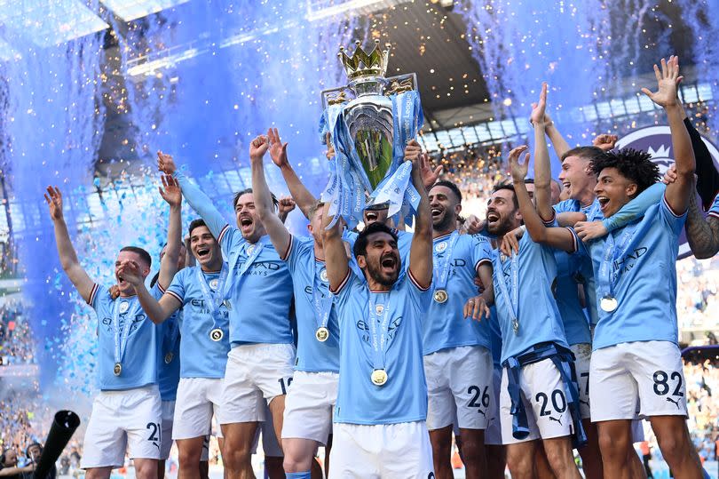 Manchester City players celebrate winning the Premier League