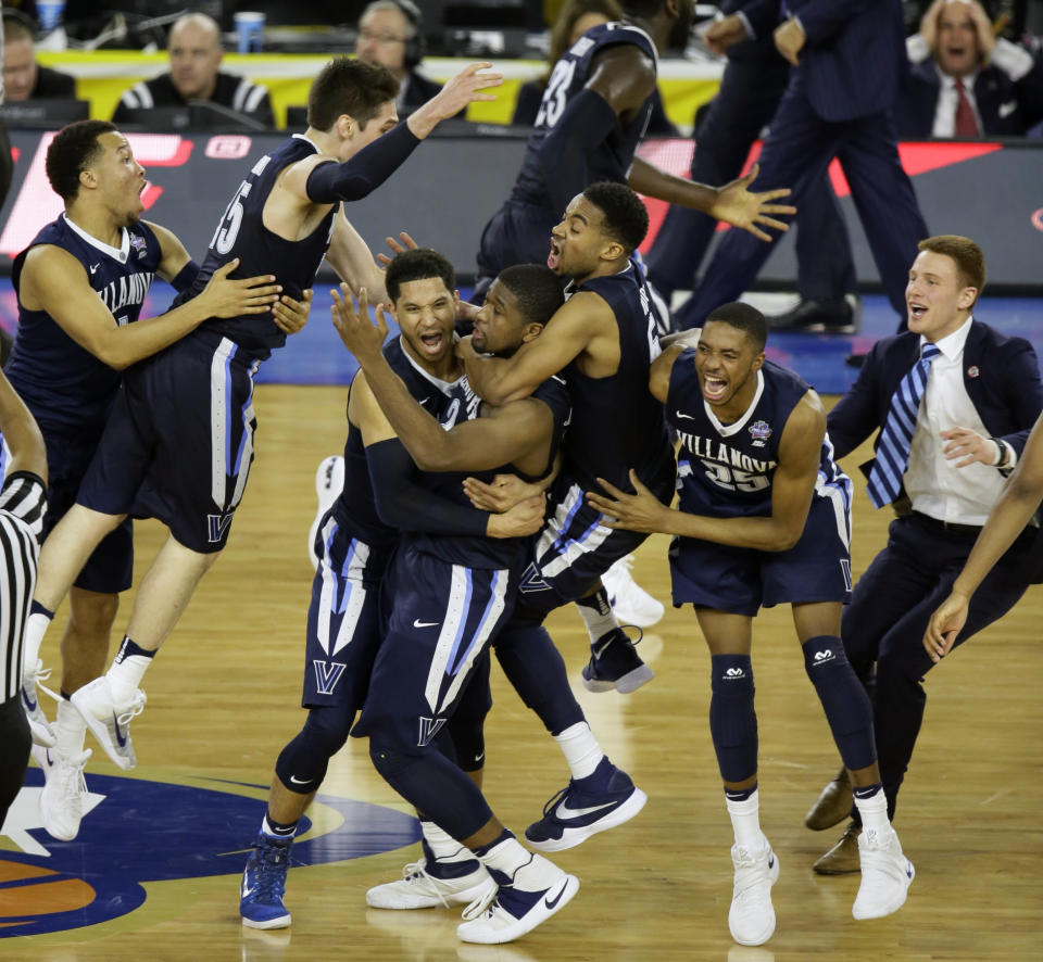 FILE - In this April 4, 2016, file photo, Villanova players celebrate after Kris Jenkins, center, hit a game winning three point basket in the closing seconds of the NCAA Final Four tournament college basketball championship game, in Houston. Villanova won 77-74. The 2010s had some of the greatest NCAA Tournament games in college basketball history, from Duke's epic win over Butler in 2010 to Villanova's last-second win over North Carolina in 2016.(AP Photo/Charlie Neibergall, FIle)