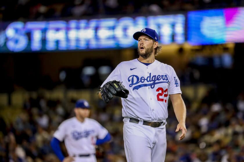 Dodgers starting pitcher Clayton Kershaw walks back to the mound after striking out a batter against the Diamondbacks