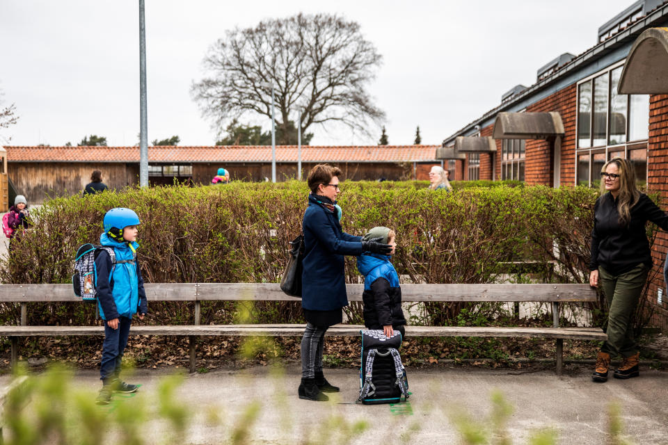 Parents with their children stand in a socially-distanced queue waiting to enter a school in Copenhagen, Denmark, April 15, 2020. (Photo: Ritzau Scanpix Denmark / Reuters)