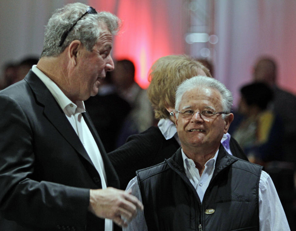 Art Sherman, right, trainer of Kentucky Derby favorite California Chrome, talks with Mike Pegram, left, part owner of second choice Hoppertunity, after the post position draw for the Kentucky Derby horse race at Churchill Downs in Louisville, Ky., Wednesday, April 30, 2014. (AP Photo/Garry Jones)