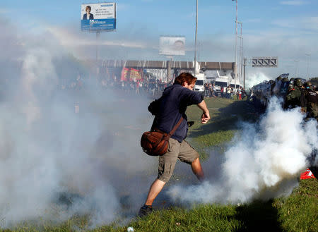 A protestor kicks back a tear gas canister to Argentine gendarmerie during clashes as demonstrators blocked a road in Buenos Aires, Argentina, April 6, 2017. REUTERS/Martin Acosta