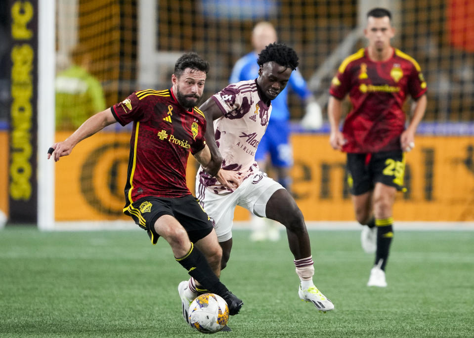 Seattle Sounders midfielder João Paulo (6) drives the ball next to Portland Timbers midfielder Santiago Moreno during the second half of an MLS soccer match Saturday, Sept. 2, 2023, in Seattle. The teams played to a 2-2 draw. (AP Photo/Lindsey Wasson)