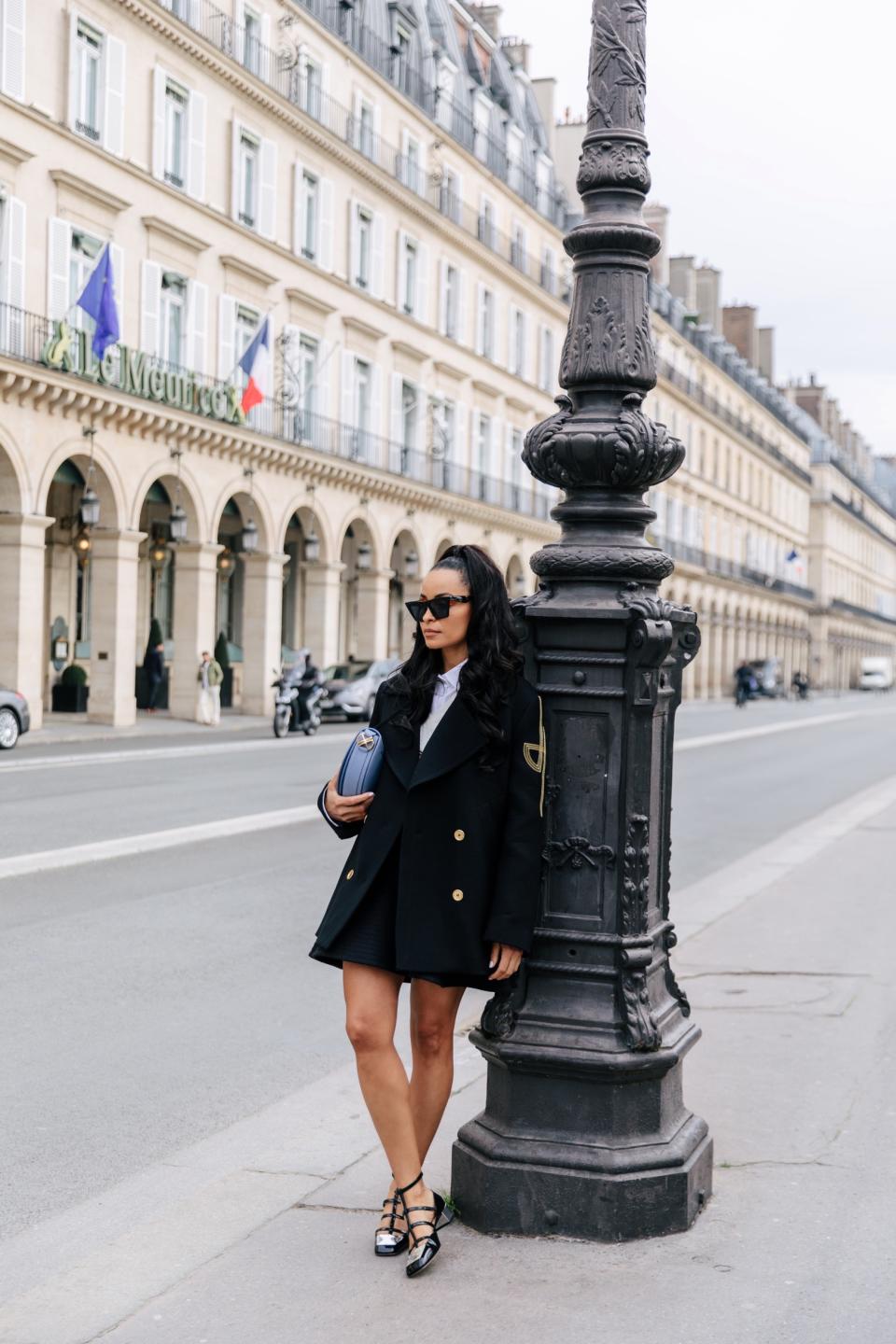 De Silva wears Dior’s black patent calfskin La Parisienne Dior ballerina flat. - Credit: Allie Provost