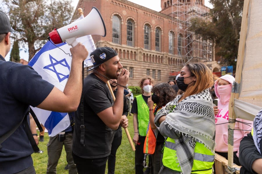 LOS ANGELES, CALIFORNIA – APRIL 25: An Israeli man, holding a flag, argues with a pro-Palestinian student as pro-Palestinian students gather to protest against Israeli attacks on Gaza at University of California (UCLA) in Los Angeles, California, United States on April 25, 2024. (Photo by Grace Hie Yoon/Anadolu via Getty Images)