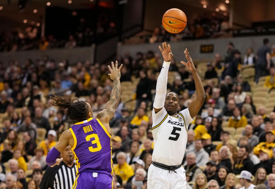 Missouri Tigers guard D'Moi Hodge (5) shoots against LSU Tigers guard Justice Hill (3) during the first half on February 1, 2023, at Mizzou Arena.