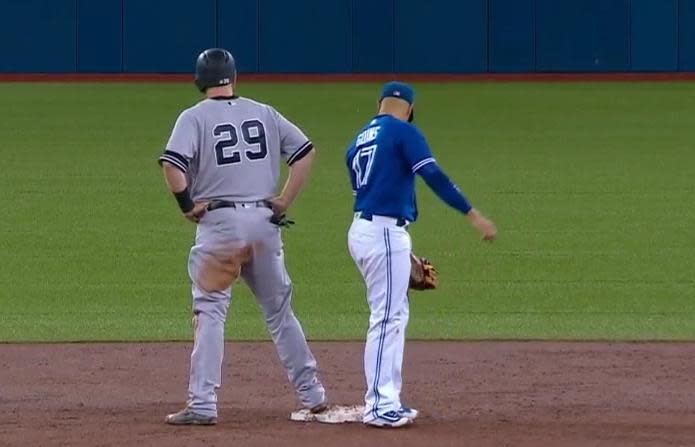 Ryan Goins waits to execute to the hidden ball trick on Todd Frazier. (MLB)