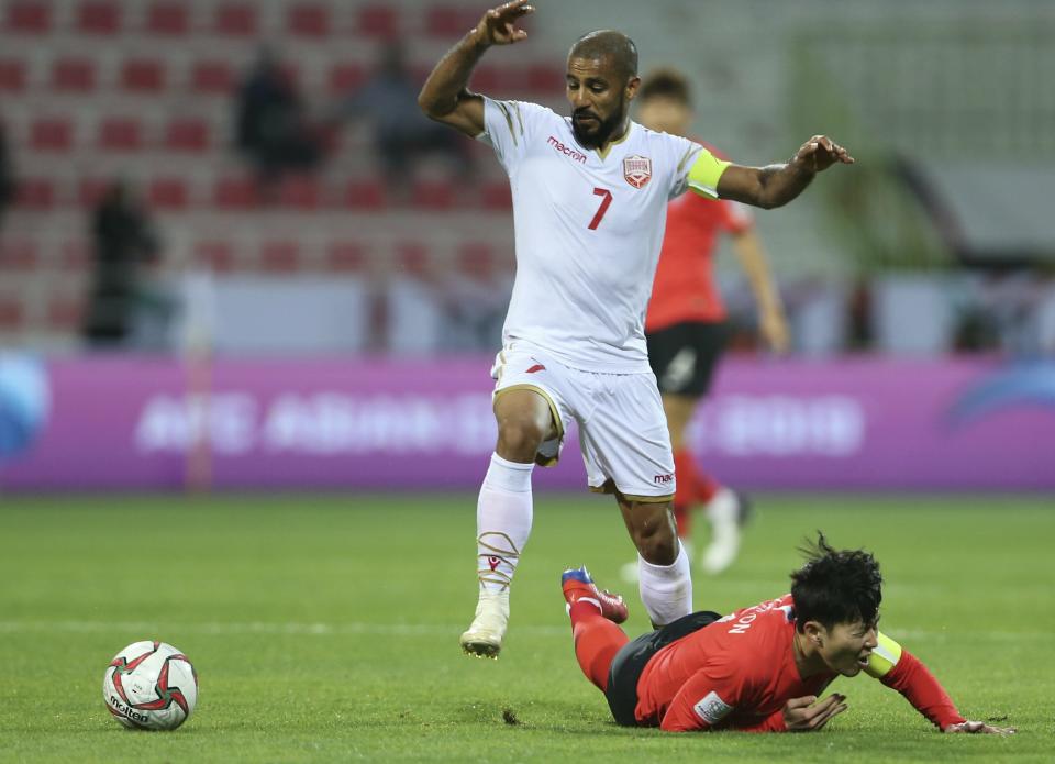 South Korea's forward Son Heung-Min, stopped by Bahrain's midfielder Ali Al Safi during the AFC Asian Cup round of 16 soccer match between South Korea and Bahrain at the Rashid Stadium in Dubai, United Arab Emirates, Tuesday, Jan. 22, 2019. (AP Photo/Kamran Jebreili)