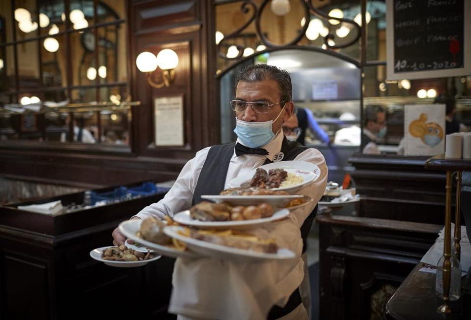 <div class="inline-image__caption"><p>A waiter during service at the Chartier Bouillon Restaurant near Grands Boulevards on Oct. 10, 2020, in Paris.</p></div> <div class="inline-image__credit">Kiran Ridley/Getty</div>