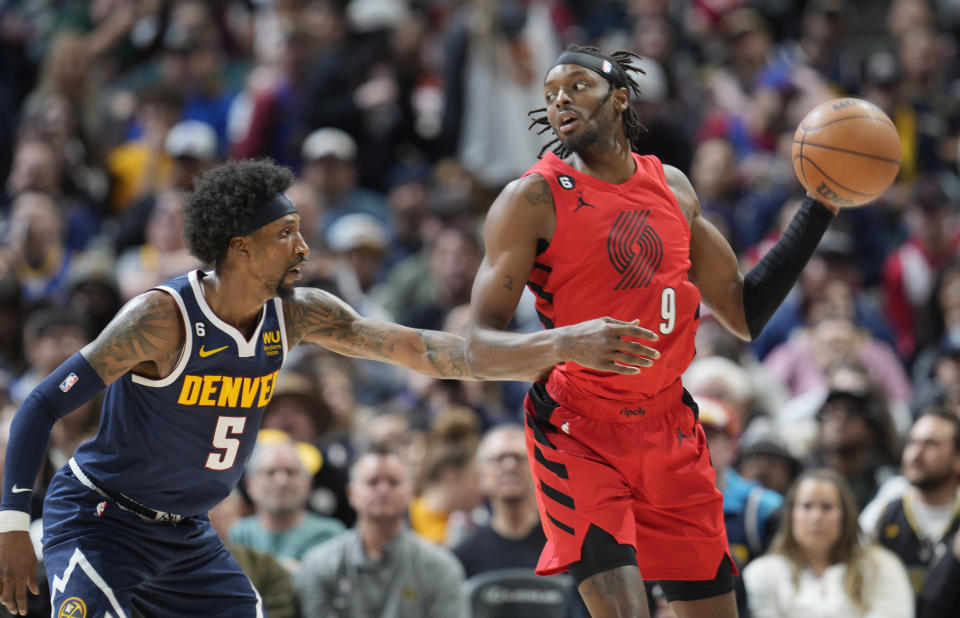 Portland Trail Blazers forward Jerami Grant, right, looks to pass the ball as Denver Nuggets guard Kentavious Caldwell-Pope defends during the second half of an NBA basketball game Tuesday, Jan. 17, 2023, in Denver. (AP Photo/David Zalubowski)