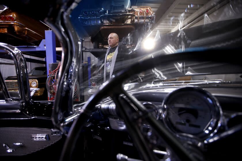 LONG BEACH, CALIF. - FEB. 1, 2023. Luis "Speedy" Rodriguez, a metal plating craftsman, shows off customized vintage Chevrolet Impala at his shop in Long Beach. (Luis Sinco / Los Angeles Times)