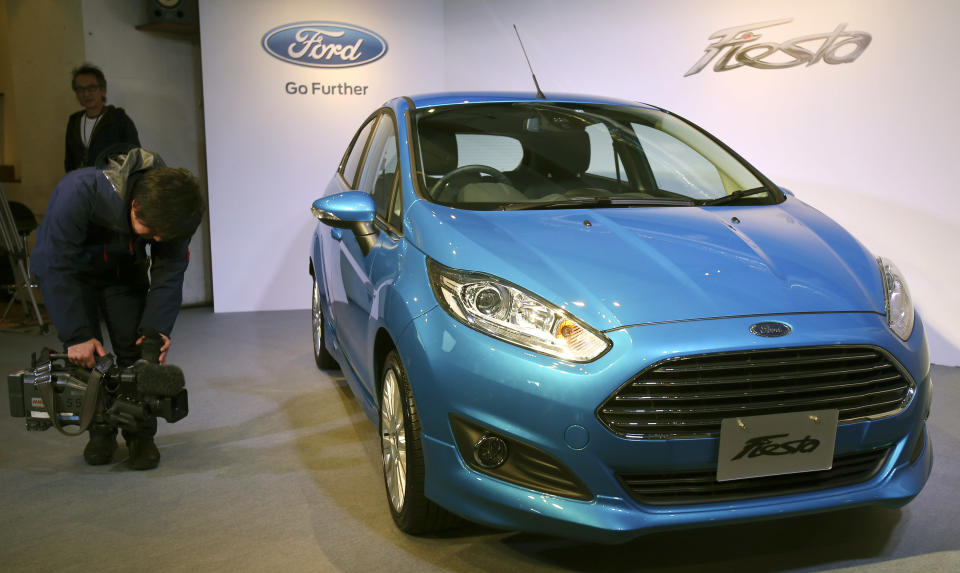 A TV cameraman films a Ford Fiesta during a press conference in Tokyo,Thursday, Jan. 9, 2014. Ford's Fiesta compact is back in Japan despite failing a decade ago in a market dominated by Toyota and other powerful local brands that specialize in small cars. (AP Photo/Koji Sasahara)