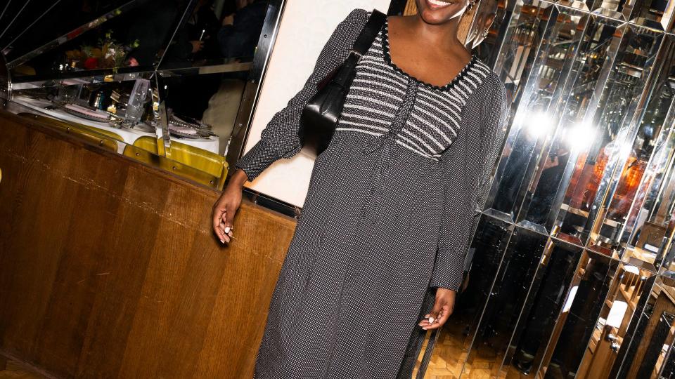 Yomi wears a Damson Madder dress to a brand dinner