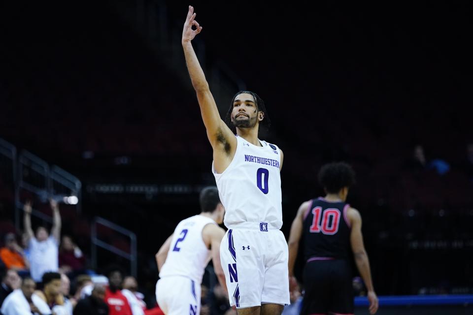 Northwestern's Boo Buie (0) celebrates after making a three-point shot during the first half of an NCAA college basketball game against Georgia Tuesday, Nov. 23, 2021, in Newark, N.J. (AP Photo/Frank Franklin II)