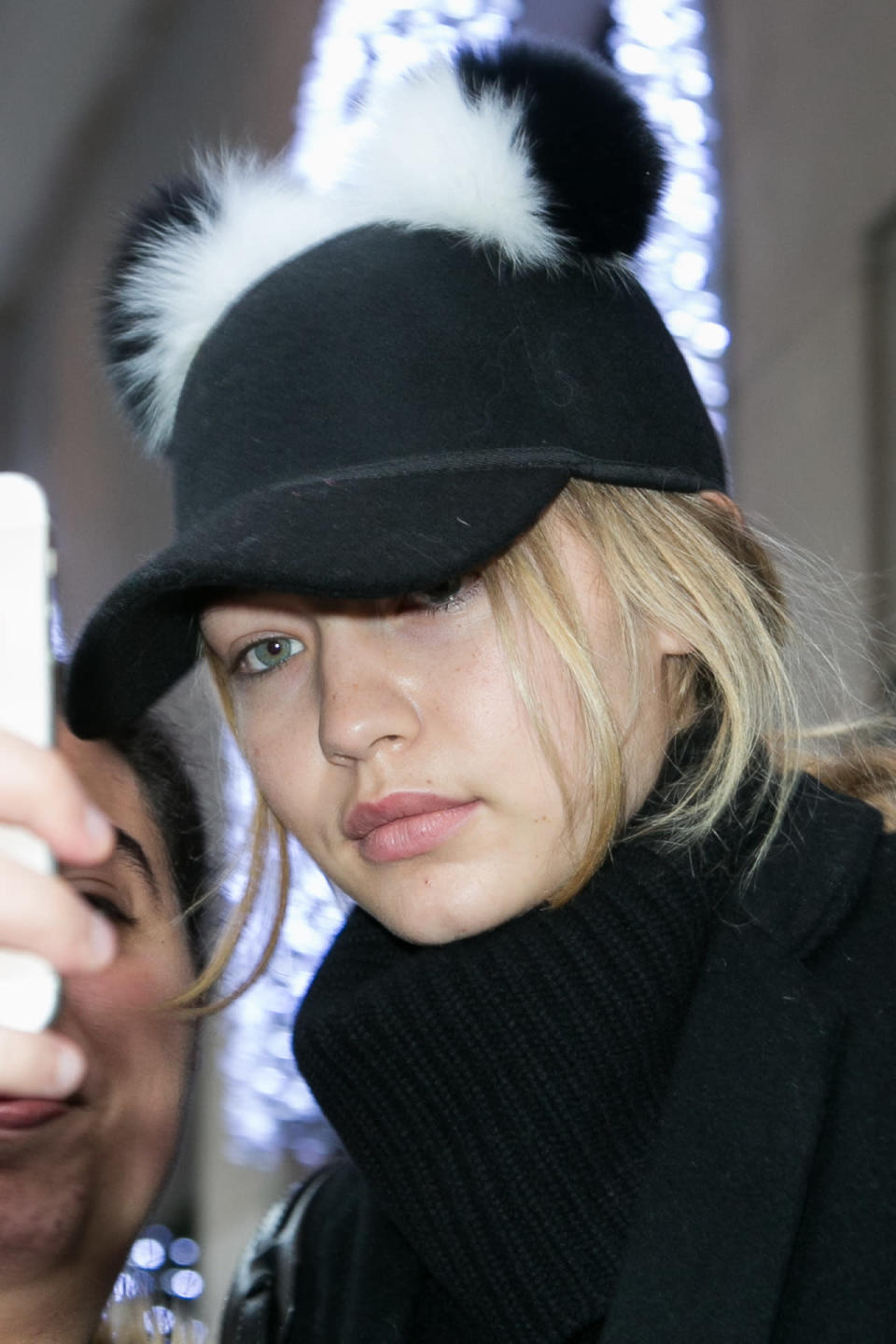 Gigi Hadid in a pom pom hat in Paris. 