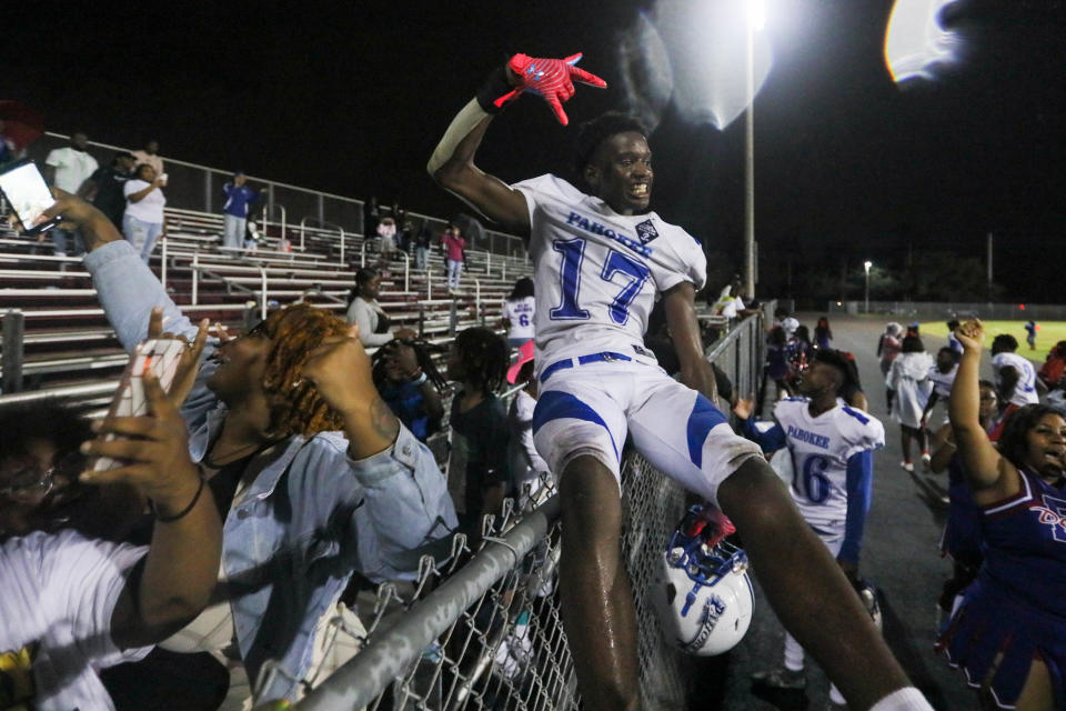 Pahokee defensive end Ja'Zyrain River (17) celebrates victory with Pahokee fans after the end of the football game between Pahokee and host Palm Beach Central on Friday, September 16, 2022, in Wellington, FL. Final score, Pahokee, 34, Palm Beach Central, 14.