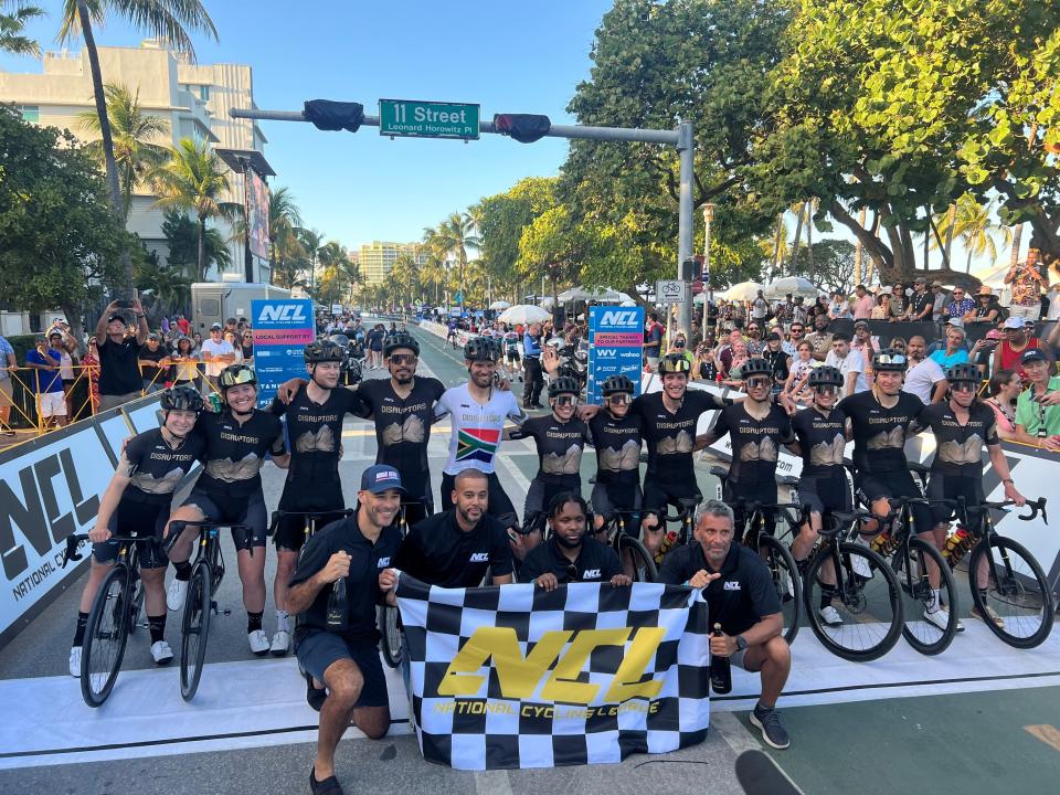 National Cycling League co-founders Paris Wallace, David Mulugheta, Randall Clark and Mark Wilkins (bottom left to right) pose for a photo with the Denver Disruptors race team after winning the Miami Invitational, the NCL's first event in Miami Beach, Fla. on Saturday, April 10, 2023.