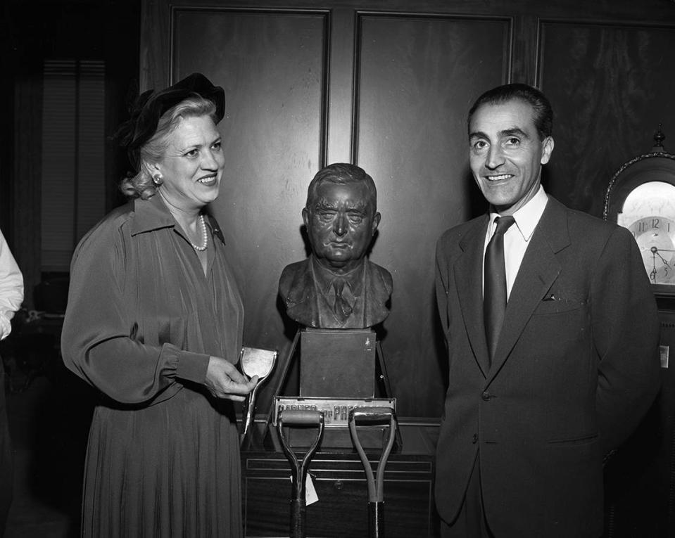 Sept 27, 1950: Robert Ricci, head of a Paris dress and perfume house, learns about Texas from Jacqueline Cochram, noted woman flier who had her own cosmetics business, as they chat before a bust of John Nance Garner in the office of Amon Carter.