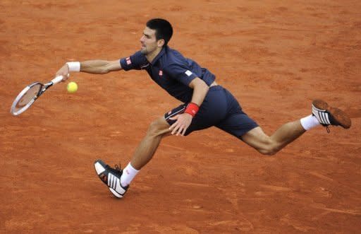 Serbia's Novak Djokovic stretches to make a return to Rafael Nadal during the French Open men's singles final at Roland Garros stadium in Paris on June 10. Nadal took the first two sets 6-4, 6-3 before Djokovic fought back to win the third 6-2 on a rain-affedted day
