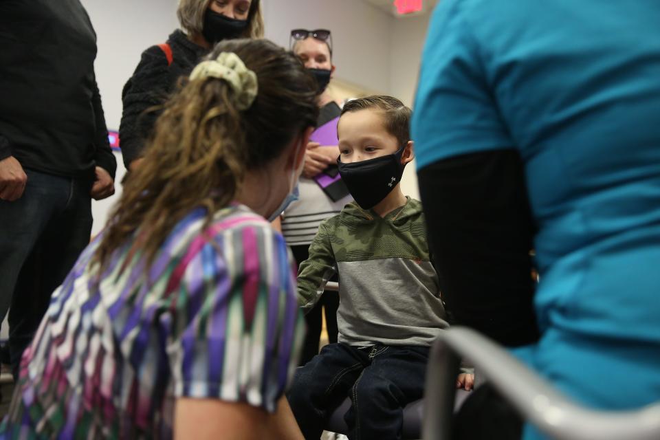 Javier Pinon, 5-years-old, is comforted by child life specialist Jane Bragg before he gets his COVID-19 vaccine Monday, Nov. 8, 2021, at the El Paso Children's Hospital. Children ages five to 11 are eligible to receive their COVID-19 vaccines.